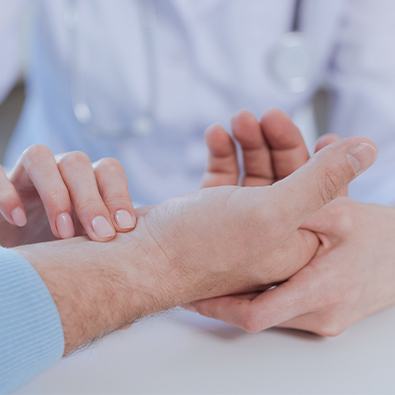 Doctor examining hand of patient with arthritis