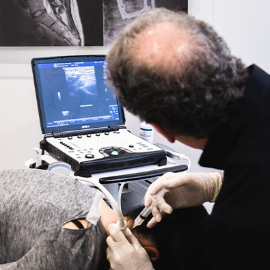 Dr. Tortland using diagnostic injections and ultrasound system