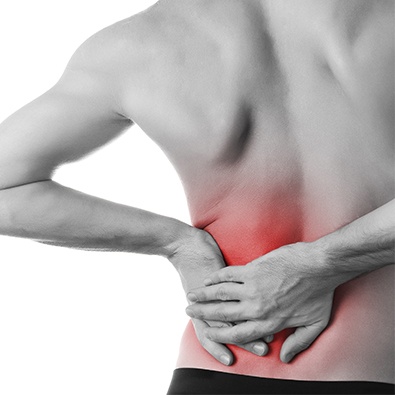 Man with low back pain holding hip