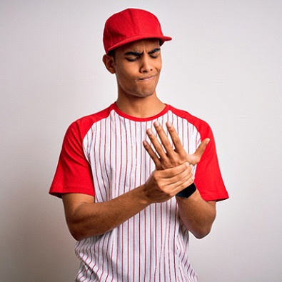 young baseball player with symptoms of hand arthritis  