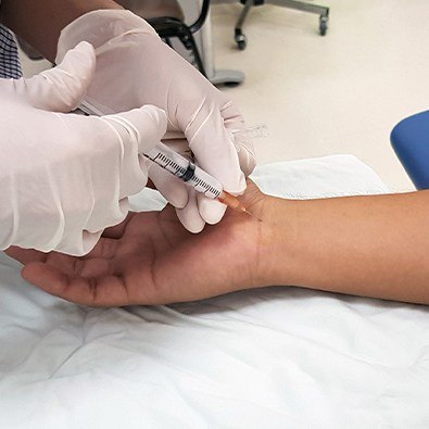Doctor providing injection treatment for arthritis