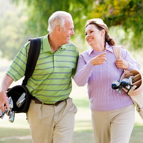 Man and woman smiling after calcific tendinitis treatment