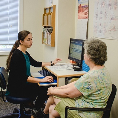 Team member discussing calcific tendinitis with patient