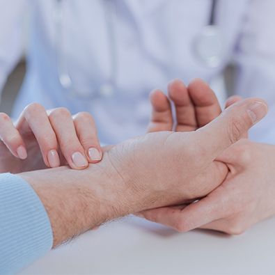 Doctor examining wrist of patient with carpal tunnel syndrome
