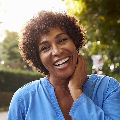 Woman smiling after treatment for chronic pain