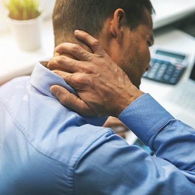 Man with chronic pain holding his neck