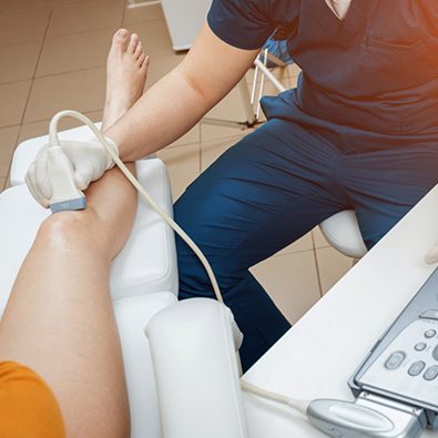 Medical professional using ultrasound on patient’s knee