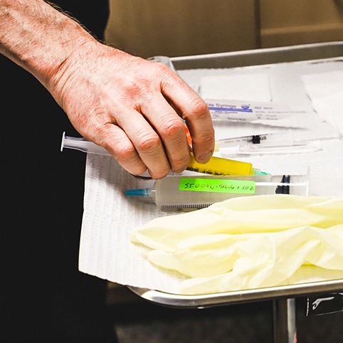 Doctor lining up needles for fluoroscopy guided injections