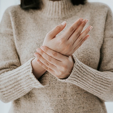 Patient with carpal tunnel syndrome holding wrist