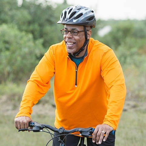 Man riding bike after treatment for hip impingement
