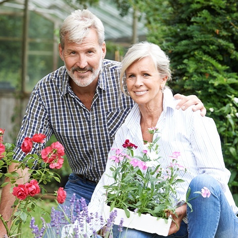 Older man and woman working in the garden after treatment for hip osteoarthritis