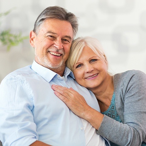 Older man and woman smiling thanks to diagnosis using ultrasound