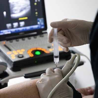 Doctor injecting patient's knee