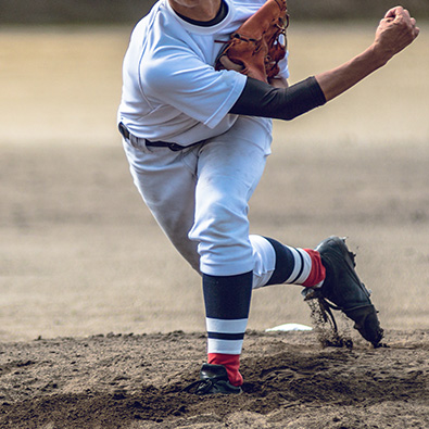 Preteen playing baseball after little league elbow treatment