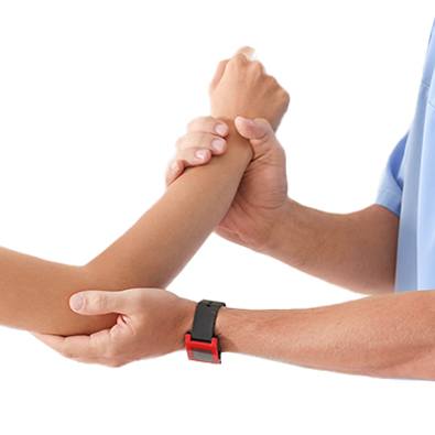 Doctor examining young patient's arm for signs of little league elbow