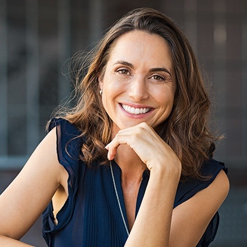 Woman smiling after treatment for chronic pain