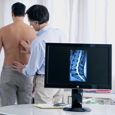 Doctor examining patient's back