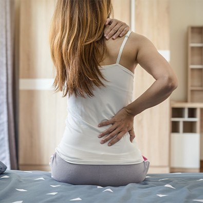 Woman in pain holding her lower back