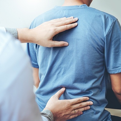 Doctor examining patient's musculature