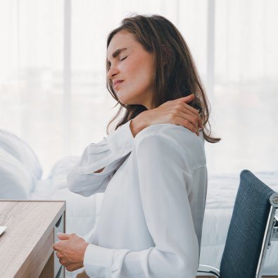 Woman in pain holding her neck