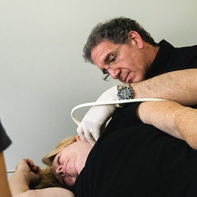 Dr. Tortland examining patient's neck