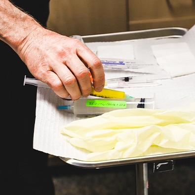 Doctor preparing needles for orthobiologic treatment