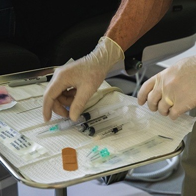 Doctor preparing tools to treat pitcher's elbow