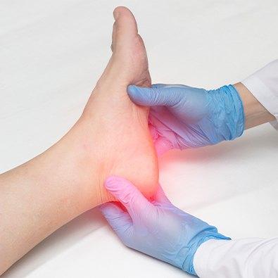 Doctor examining patient with plantar fasciitis