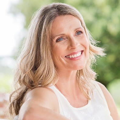 Woman smiling after pain relieving ozone therapy