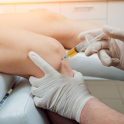 Doctor providing prolotherapy injection