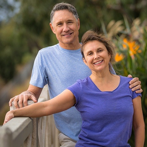 Man and woman smiling after treatment for should injury