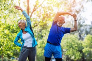 older couple stretching outdoors