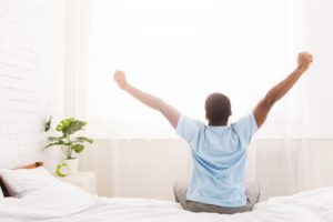 man waking up feeling great 