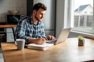 man working at kitchen table 