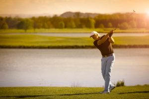 older man playing golf