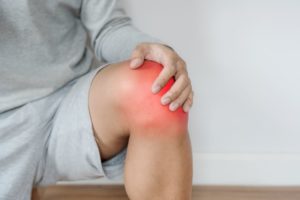 Person suffering from joint inflammation in the knee