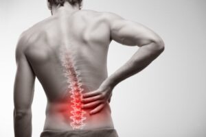 Man with lower back pain viewed from behind 